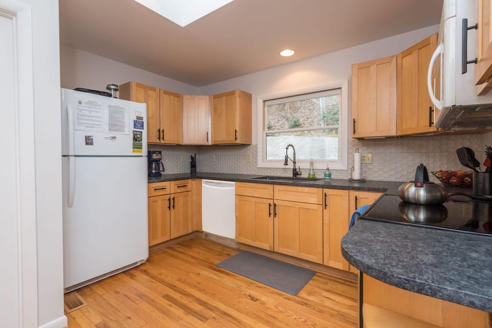The kitchen features modern stainless steel appliances, generous counter space, and an open layout ideal for preparing meals and entertaining.