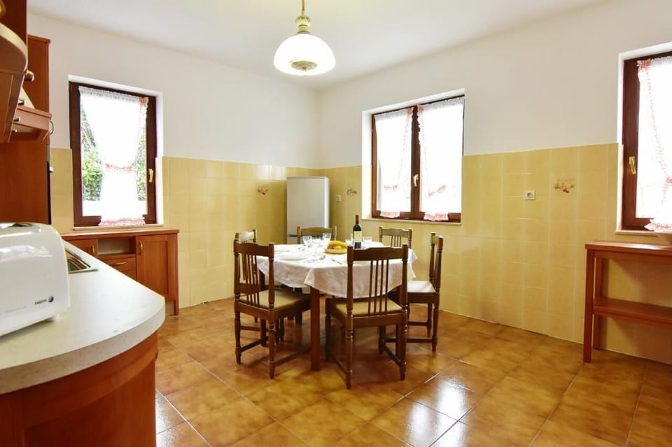 The dining table and chairs in the separate kitchen