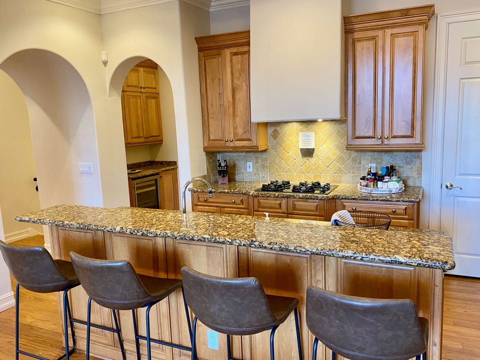 The bar area behind the kitchen has its own wine fridge, and liquor storage.