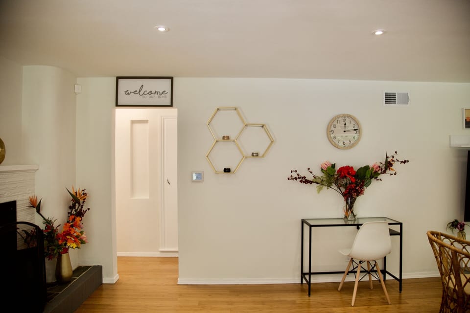 Living room w/ walkway into bedroom and first floor bathroom