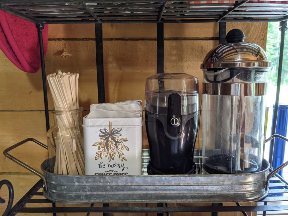 Stir sticks, hot chocolate, a coffee grinder and a French press.