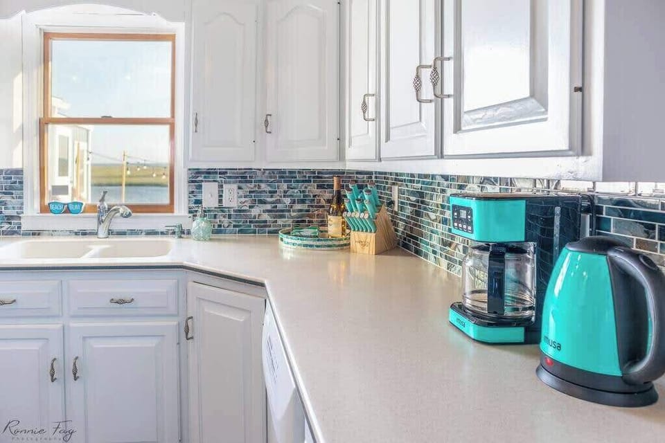 Well-equipped kitchen with modern appliances, cookware, and margarita maker.