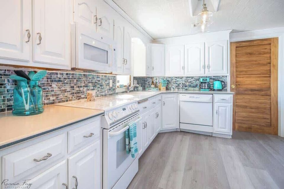 Well-equipped kitchen with modern appliances, cookware, and margarita maker.