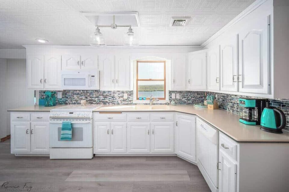 Well-equipped kitchen with modern appliances, cookware, and margarita maker.