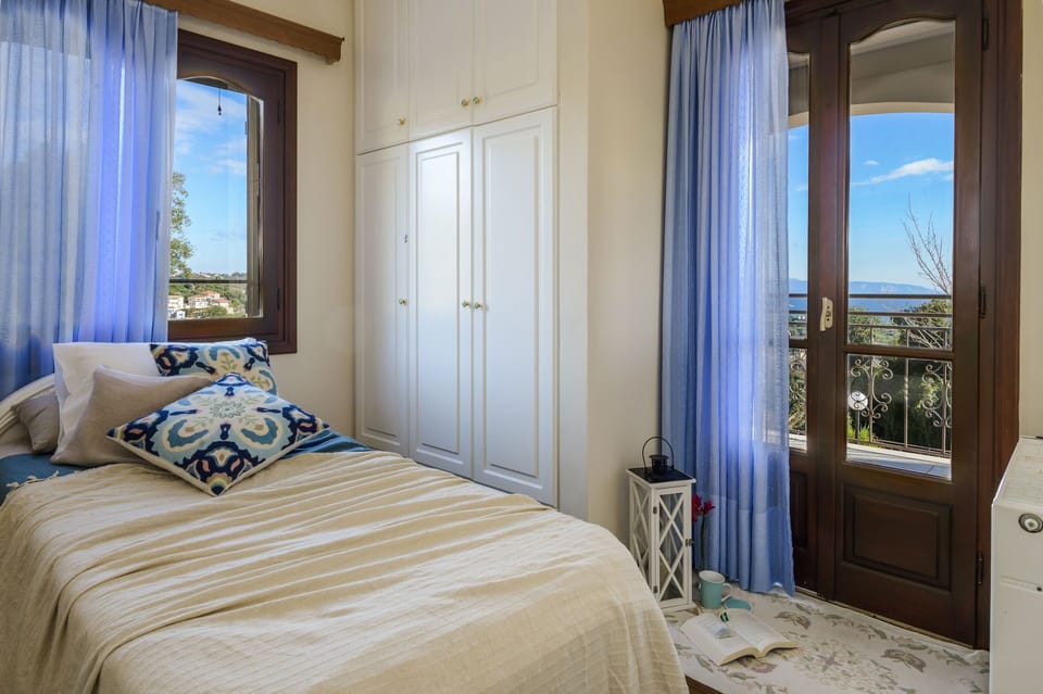 Third bedroom with single bed and blue sky view.