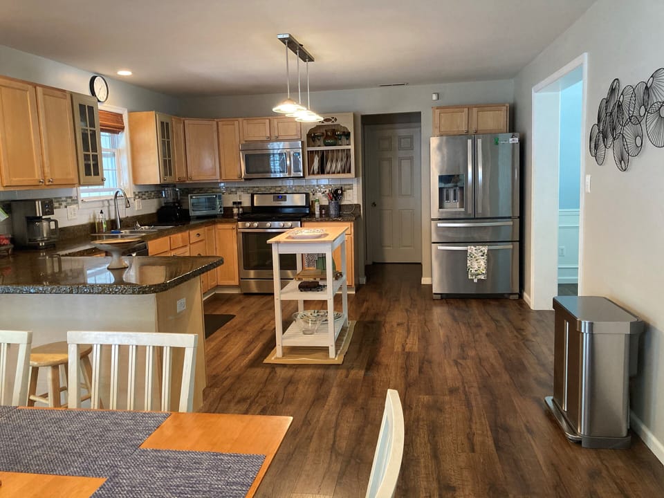 A well equipped kitchen with counter seating for 2