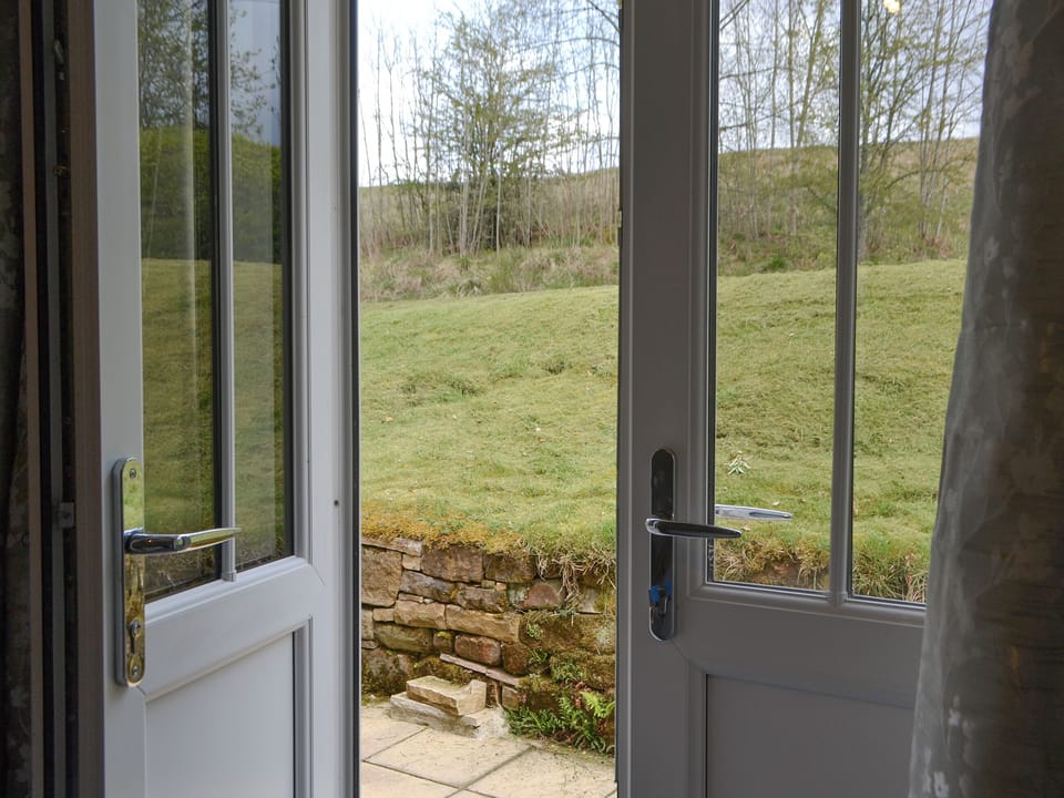 Doorway from bedroom to garden | No 2 Railway Cuttings - Railway Cuttings, Falstone, near Kielder