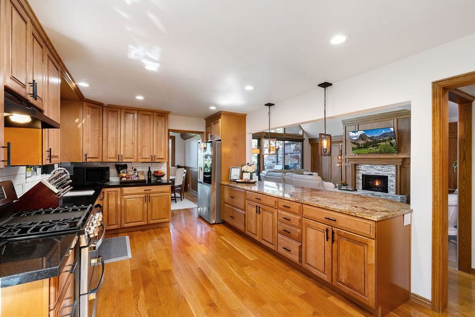 Fully stocked kitchen with gas oven and refrigerator that makes craft ice balls