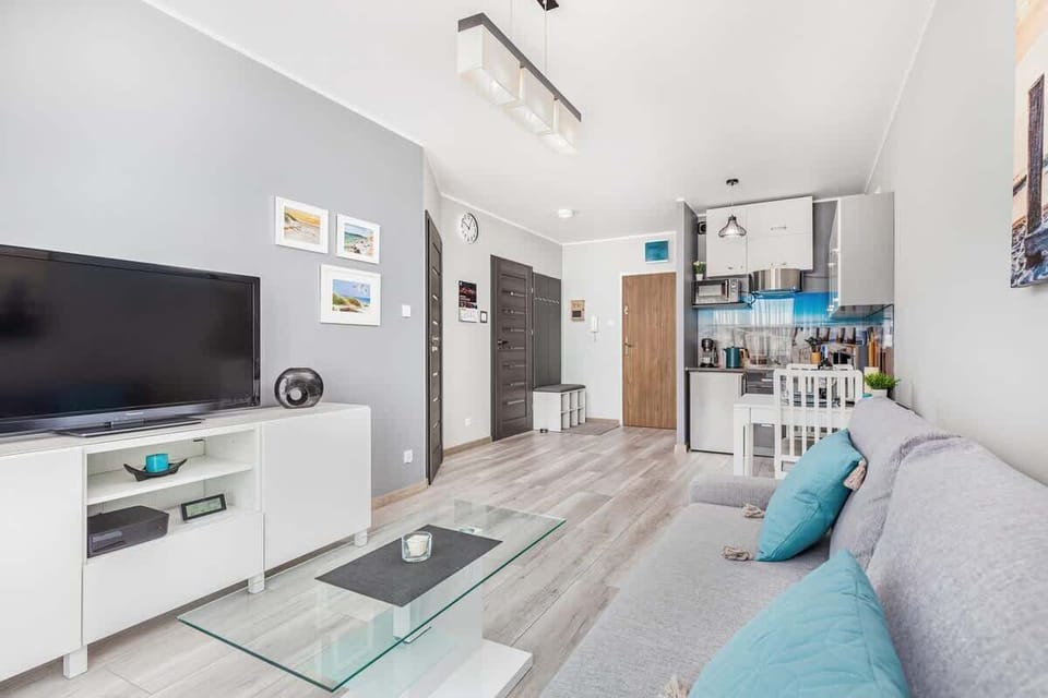 A wider perspective of the same living room, showing the sofa and additional furniture.