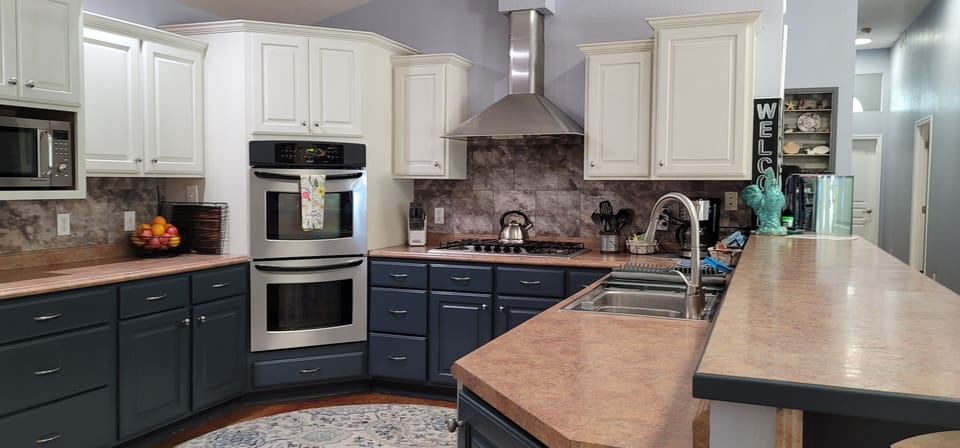 Kitchen boasts double ovens and 5 burner gas cooktop, microwave and dishwasher. 