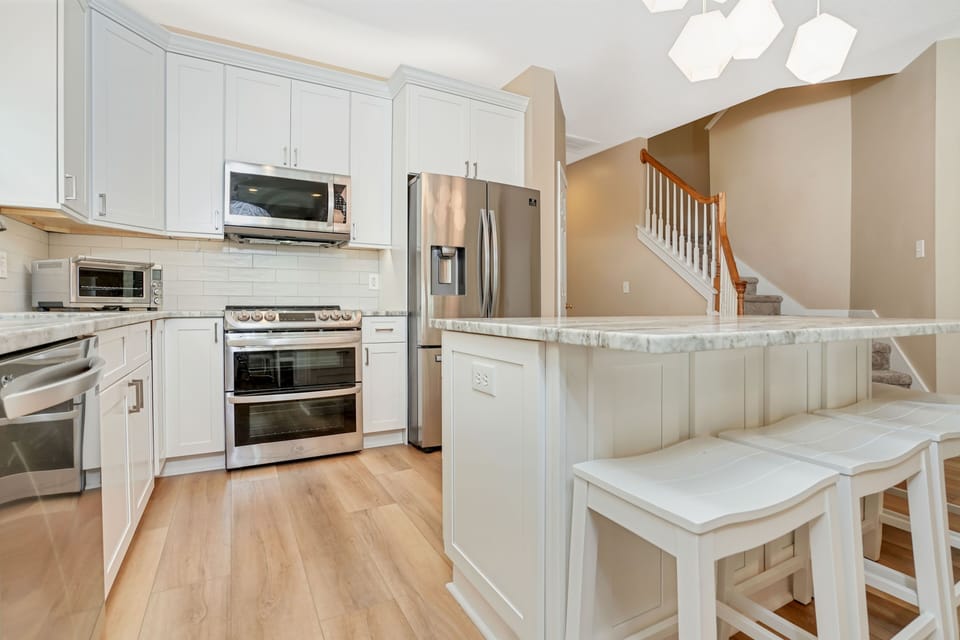 Your fully equipped kitchen features marble countertops, stainless steel appliances, and a breakfast bar perfect for morning coffee.