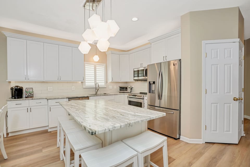 Your gourmet kitchen features stunning marble countertops, stainless steel appliances, and elegant pendant lighting for memorable meal prep.