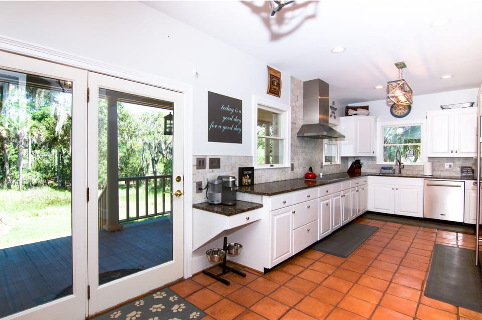 Fully equipped kitchen with exceptional counter space, stainless steel appliances, Keriug coffee maker with built-in frother, Wolf electric range, and a Sub Zero fridge.