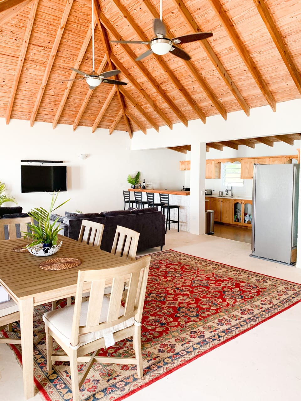 View of the dining table, living room and kitchen upstairs..