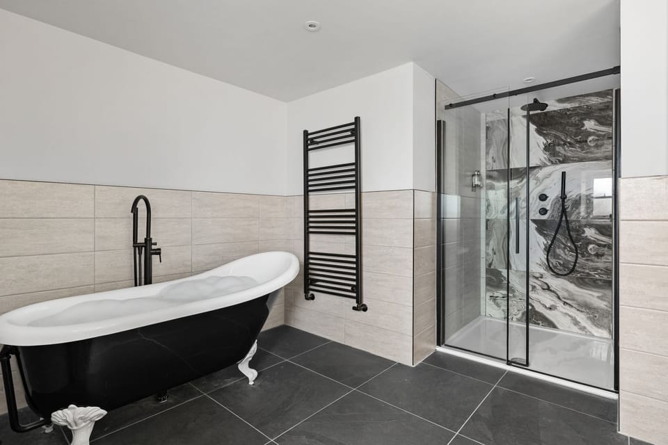Freestanding bath with heated towel rail and walk in shower - Pilgrim Suite