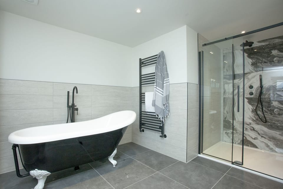 Freestanding bath with heated towel rail and walk in shower - Pilgrim Suite