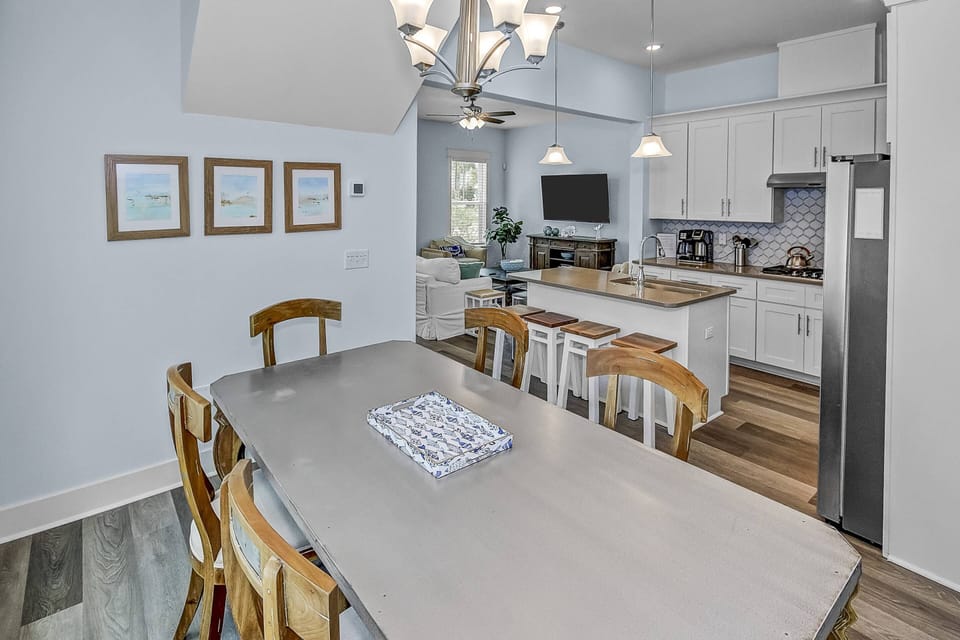 Dining area features a farmhouse-style table with seating for 6 people