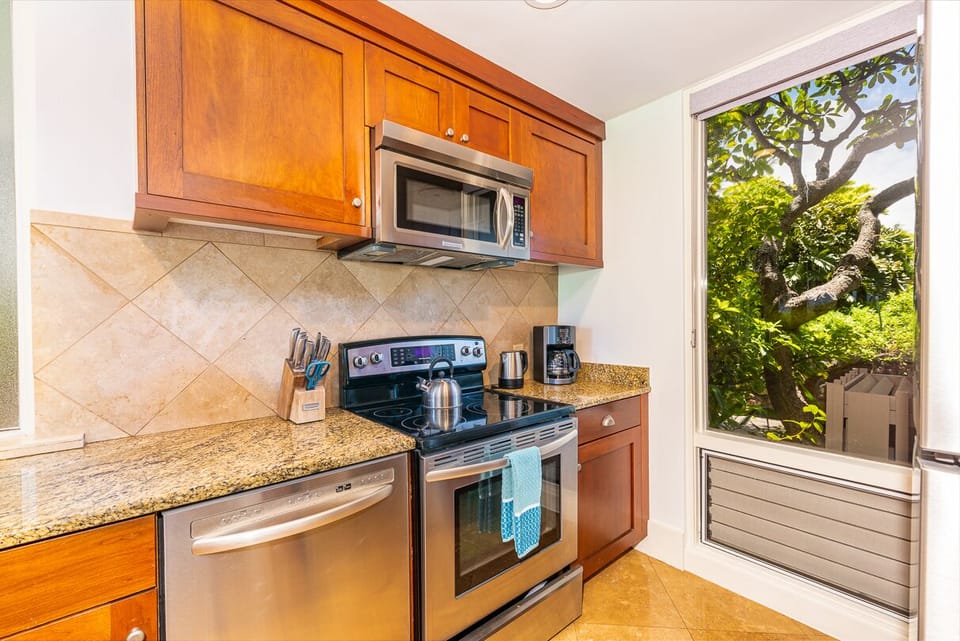 Beautiful kitchen with stainless steel appliances, granite countertops, and wooden cabinetry.
