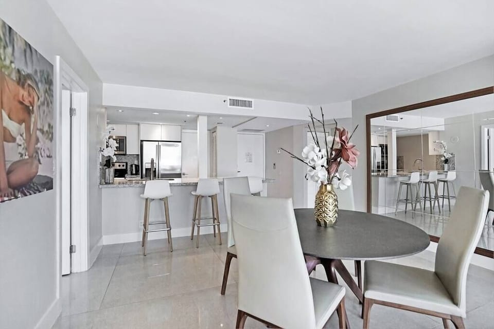 Dining area, seating at kitchen counter, fully equipped kitchen, front entrance