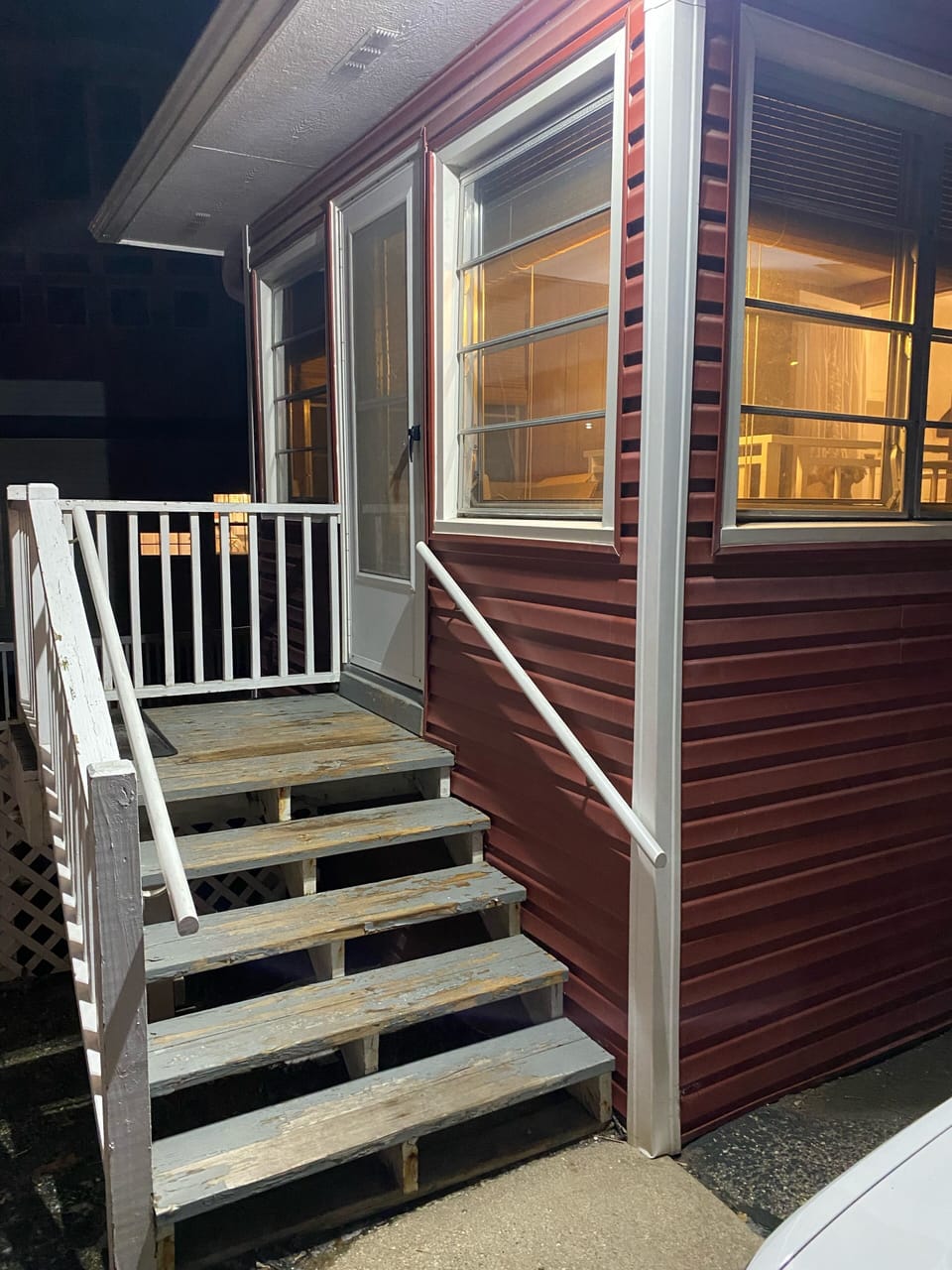 Rear entry porch with daybed and storage area.