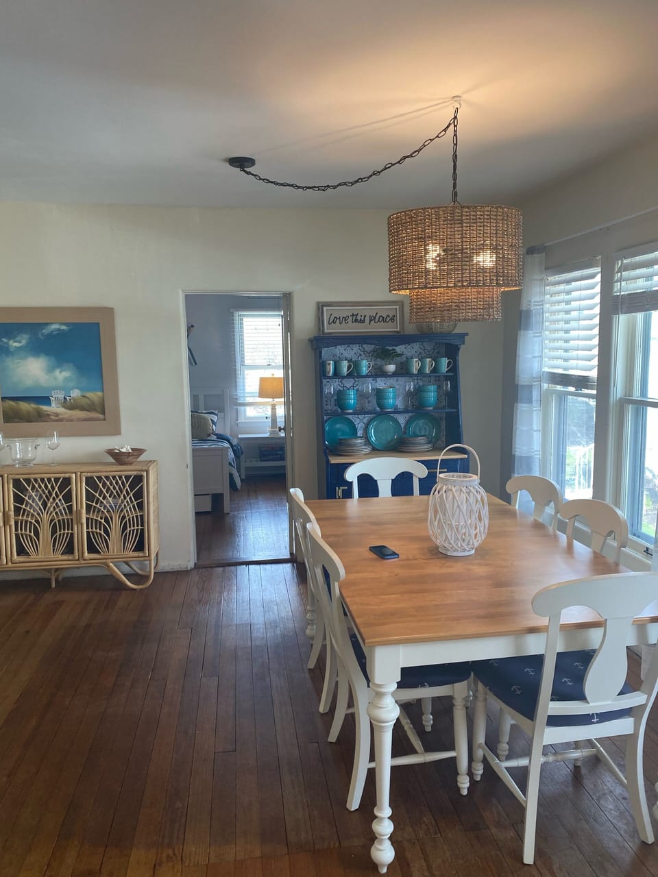 Lake style dining area with new table, chairs, hutch and light fixture.