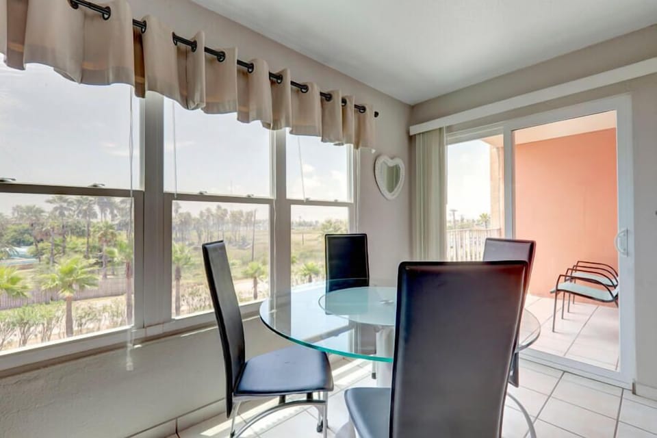 Our modern dining space has room for 4 against the backdrop of the Laguna Madre Bay and the South Padre Island water park.
