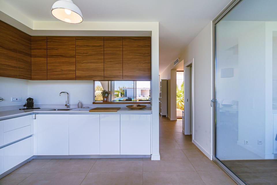 Modern open-plan kitchen with wooden upper cabinets — Villa Blue Sagres D, luxury holiday villa in Vila do Bispo