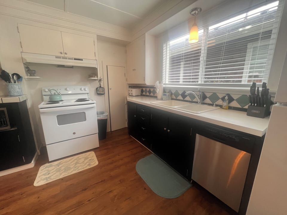 Your fully equipped kitchen features modern appliances and warm wood ceilings, creating the perfect space for preparing meals during your stay.