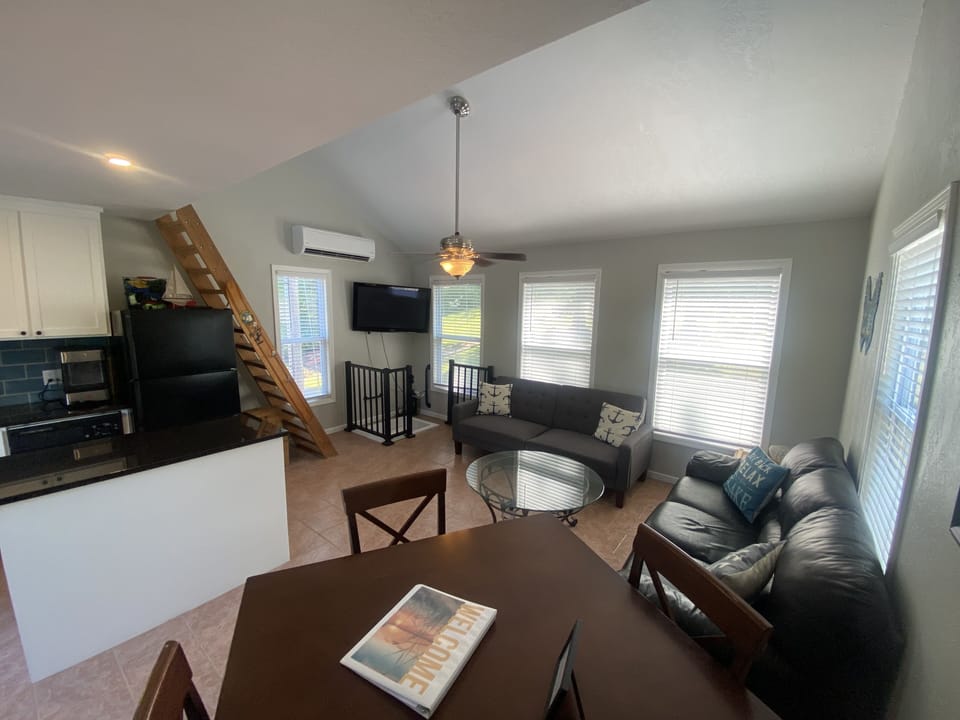Upper level with living room, kitchen, and half bath.  