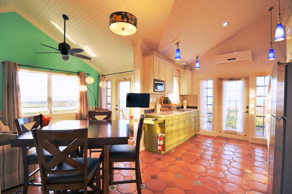 Dining table, kitchen on right, living room area on left.