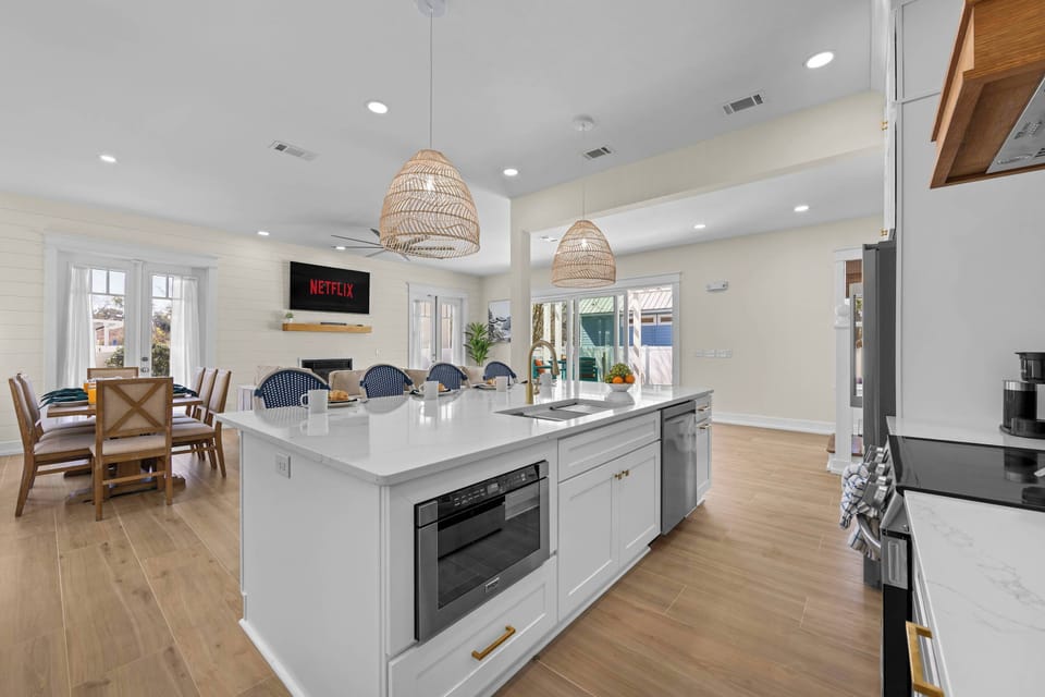 “Spacious open-concept kitchen and living area perfect for gathering after a beach day.”