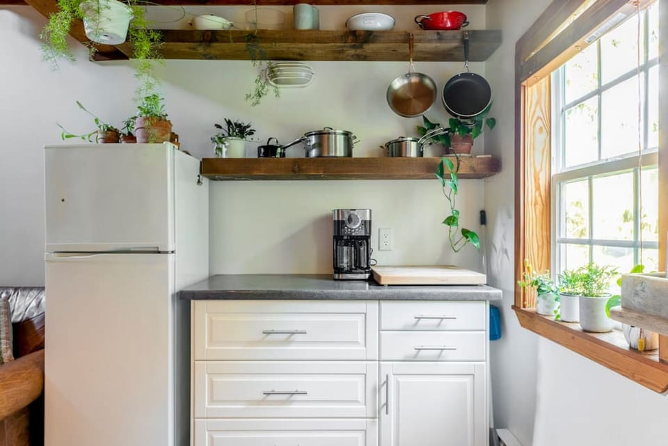 The kitchen has a full fridge and freezer, pots, pans, and drip coffee-maker.