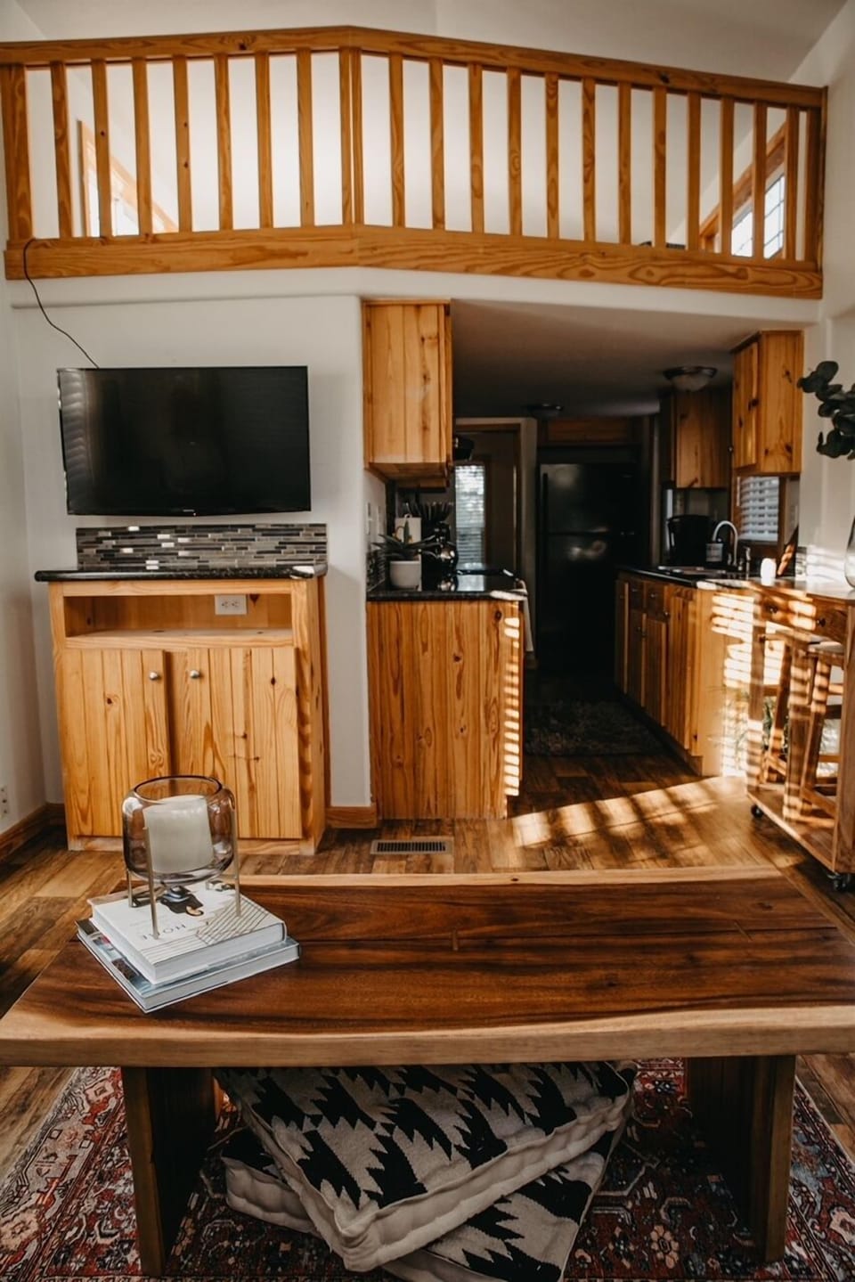 View from the couch of loft above and into kitchen.