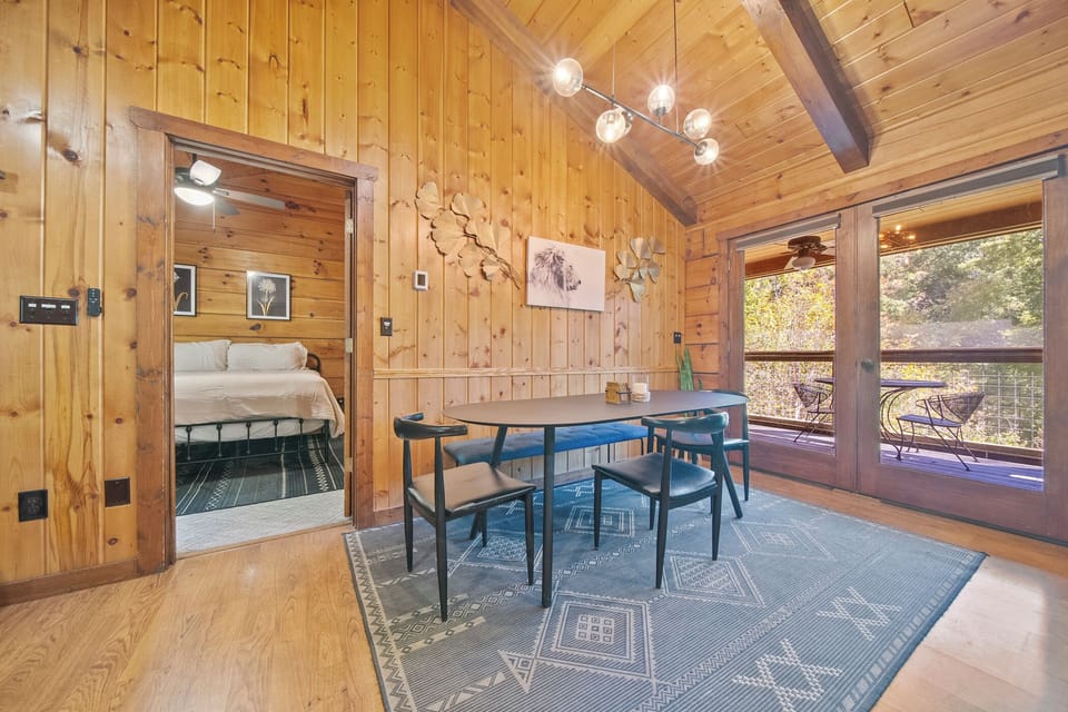 Rustic dining area with access to a deck and beautiful views.
