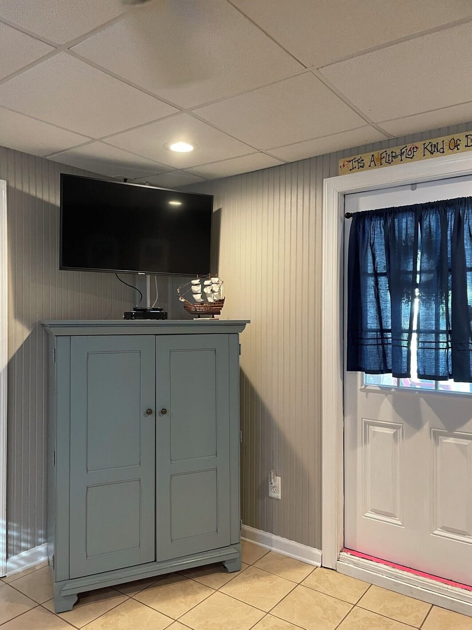 TV and storage armoire in lower unit living room 
