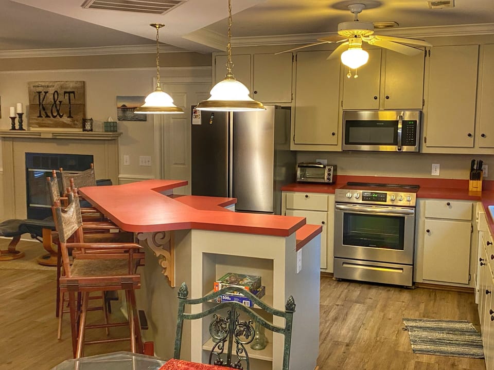 Open kitchen with island and brand new appliances 