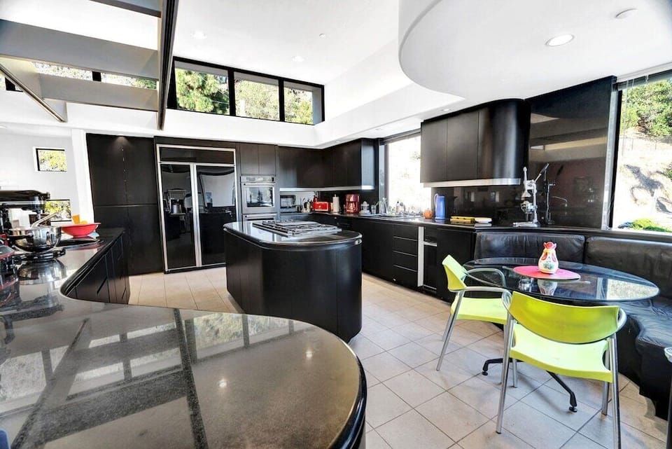 Modern kitchen w 2 sinks, SubZero fridge, gas range, oven, microwave, dish washr