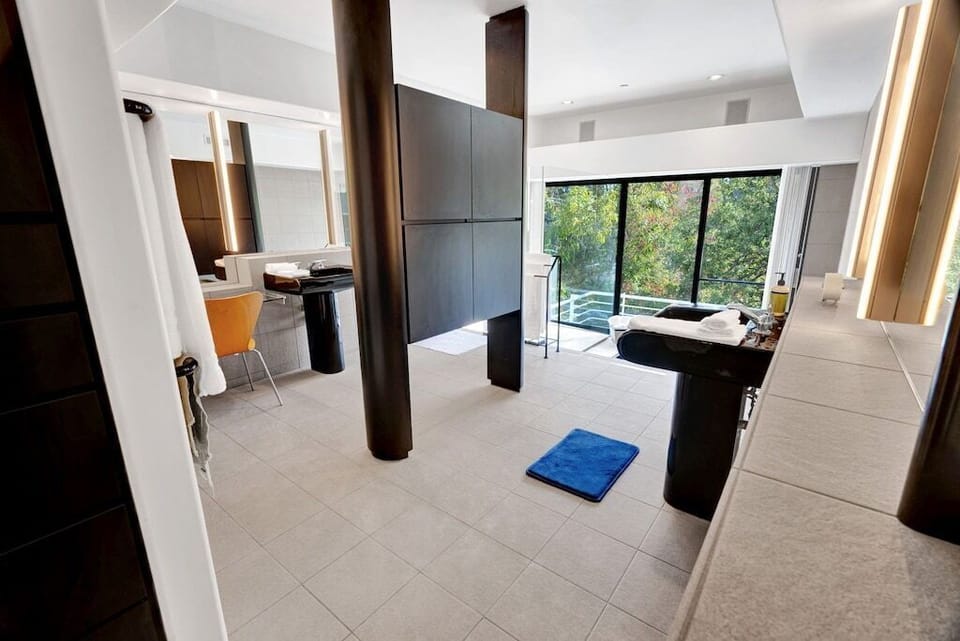 Master Bath room w soft lighting, double sinks and canyon views