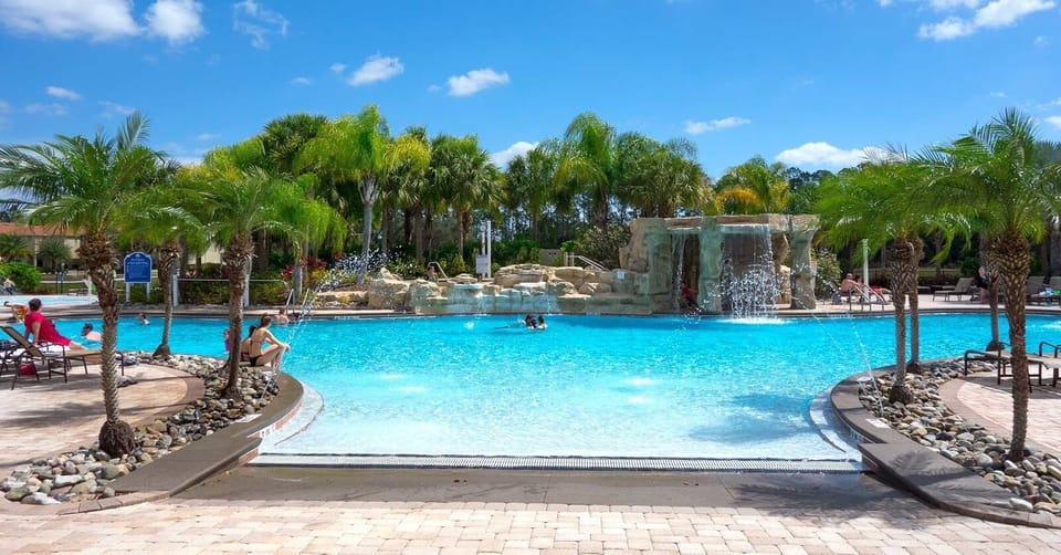 Clubhouse with pool, waterfall, slide, movie theater, gym, games room, Tiki bar