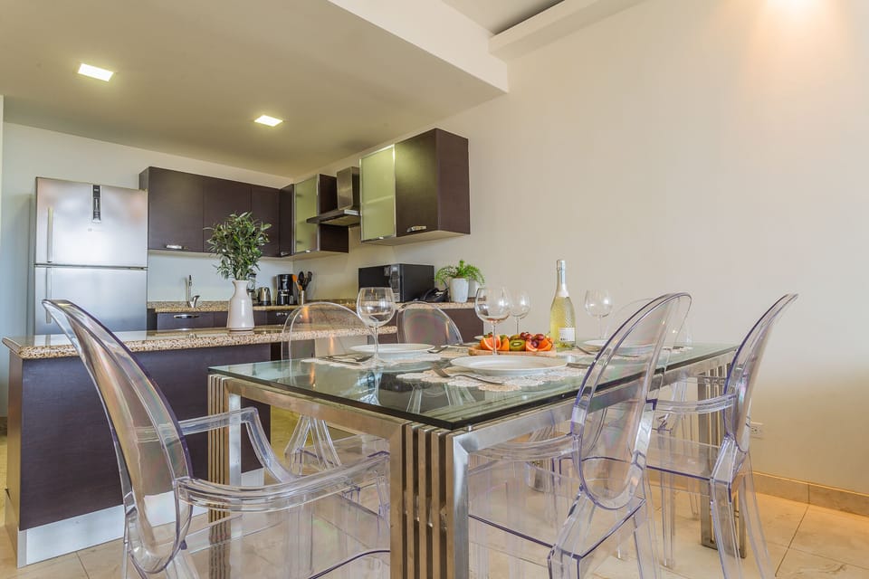 Eclat Dining Area of the lovely condo in Oranjestad Aruba - 6 Persons Dining - Functional and aesthetically pleasing storage solutions for tableware - Open layout seamlessly connecting the dining area to the kitchen and living room.