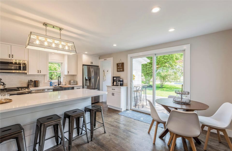 Updated eat-in-kitchen with all new appliances and view of private rear yard.