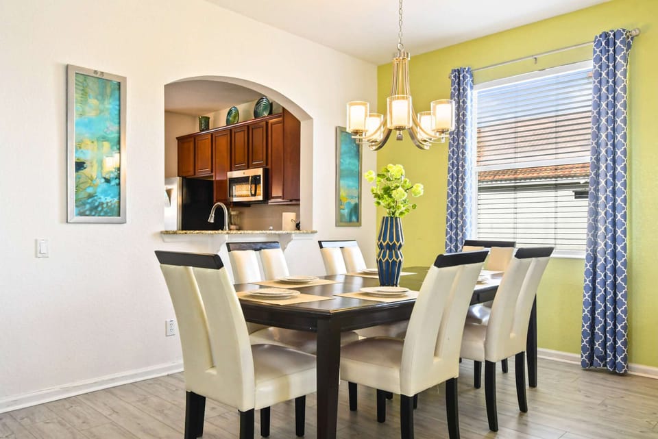 Stylish dining area with open kitchen, perfect for family meals and gatherings.