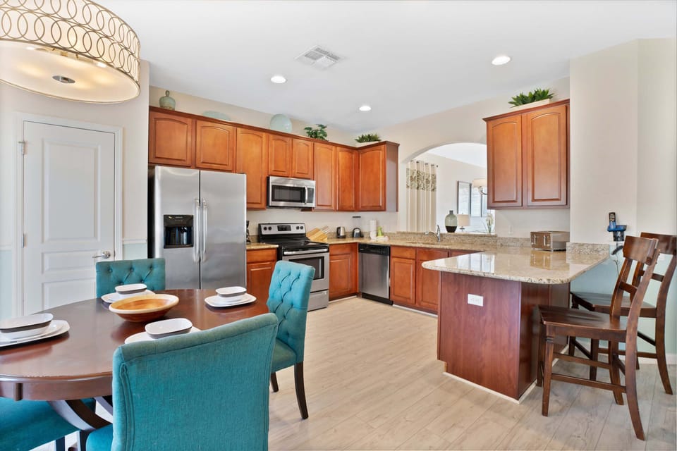Spacious kitchen with granite countertops, stainless steel appliances, and a breakfast nook.