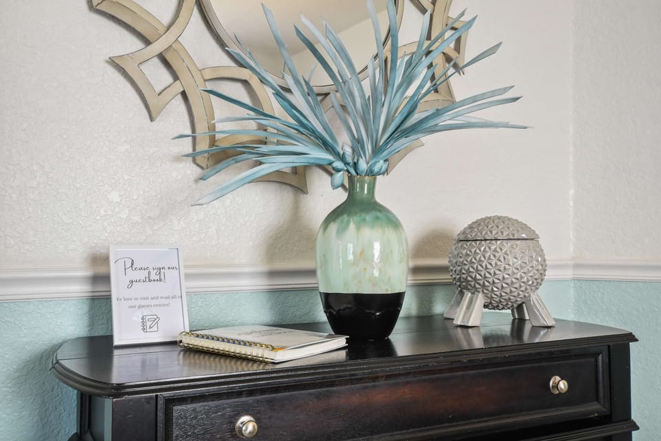 Charming entry table with guestbook, stylish decor, and a warm personal welcome.