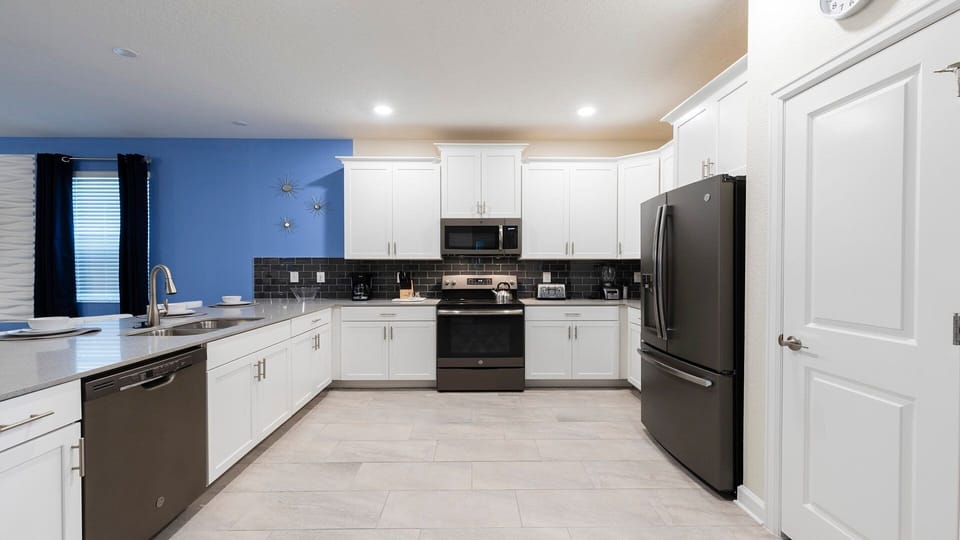 Spacious kitchen with modern appliances, quartz counters, and stylish design.