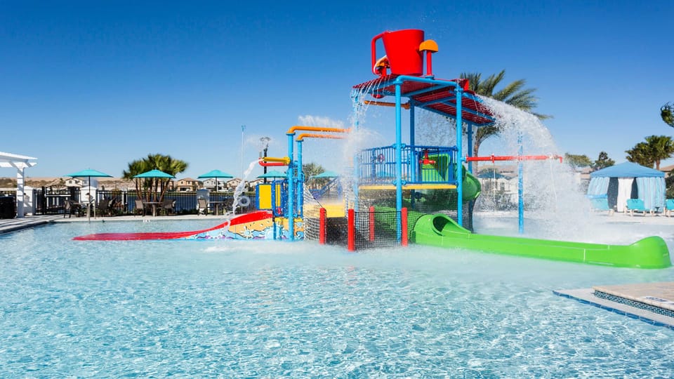 Fun splash zone with colorful slides, water jets, and a giant tipping bucket for endless family excitement.