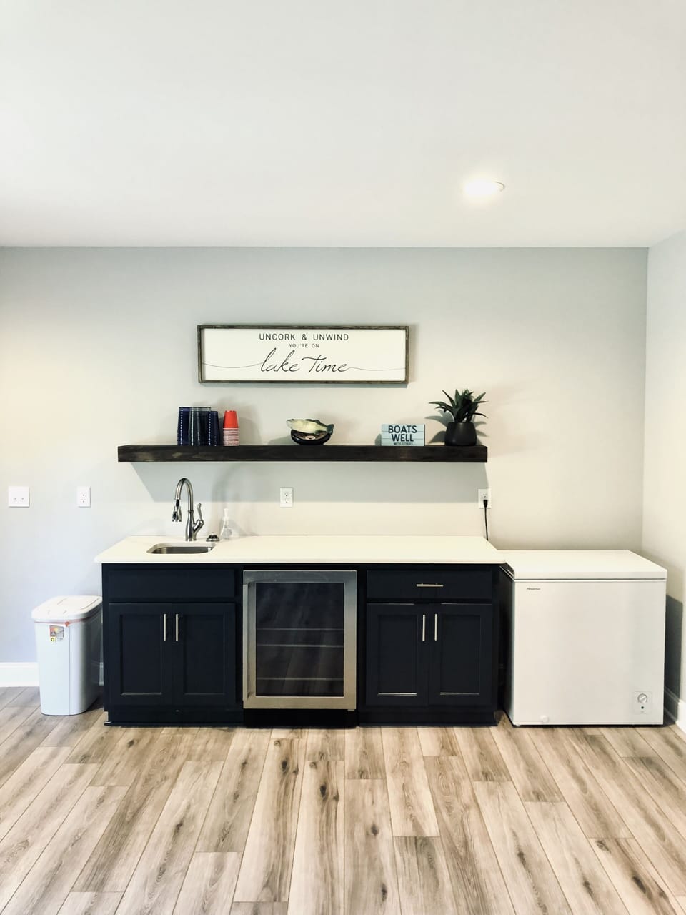 Wet bar and freezer chest 
Beach towels in cabinets 