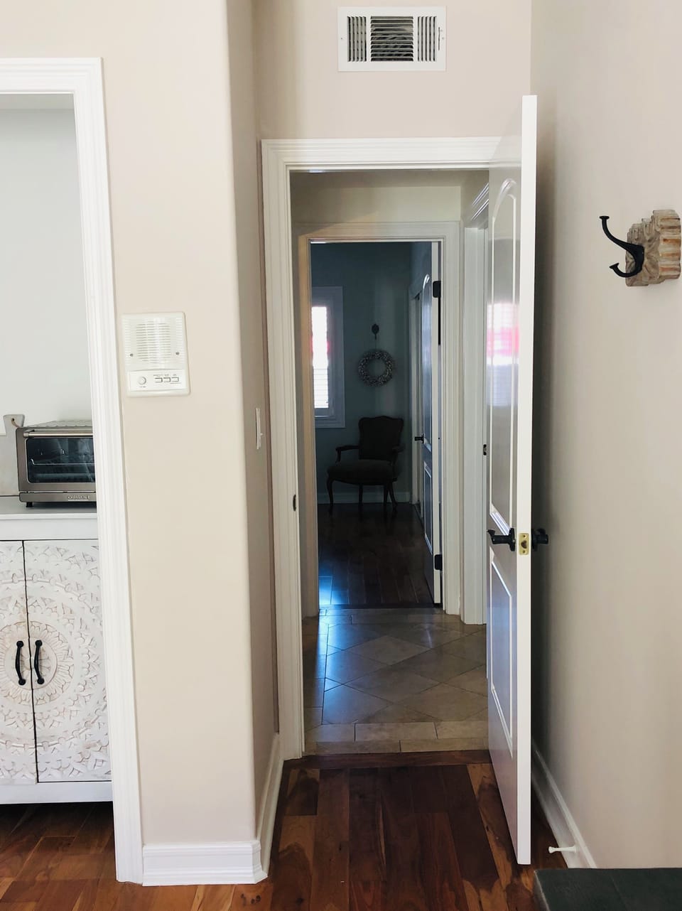 Hallway that separates the living area and bedroom. Each room has it's own door.