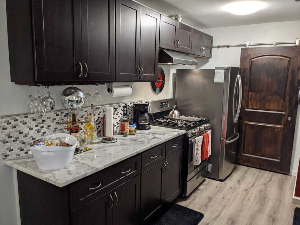 Kitchen: Full gas range (oven/stove), stainless steel full-size refridgerator.
