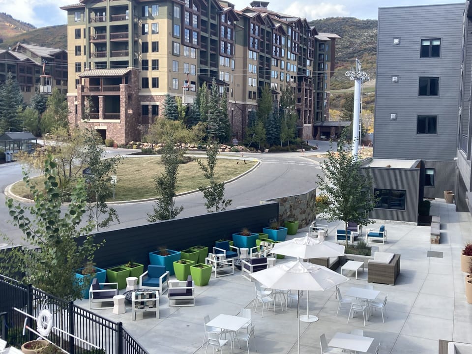 Looking north of pool-chairs and fire pits with ski storage beyond